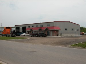 steel warehouse building with high bay doors and office area